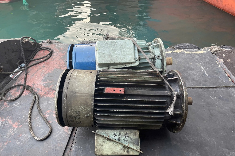 VNS technicians transferring vessel electric motors ashore for repair