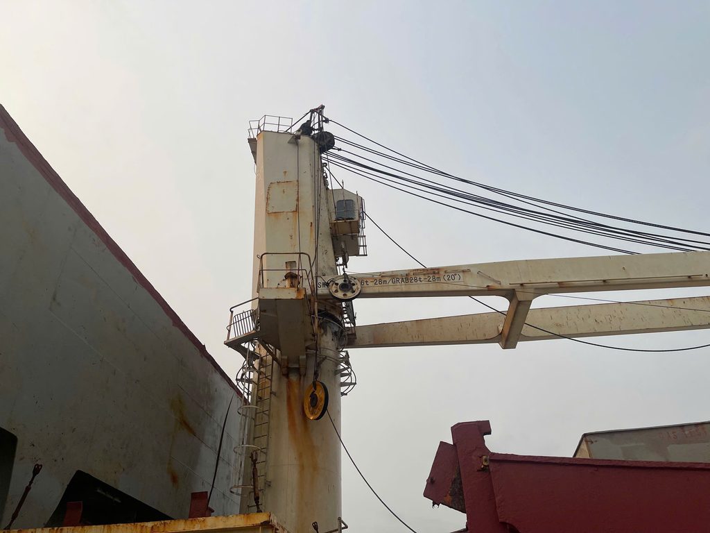 Technician replacing a pulley on a bulk carrier's deck crane