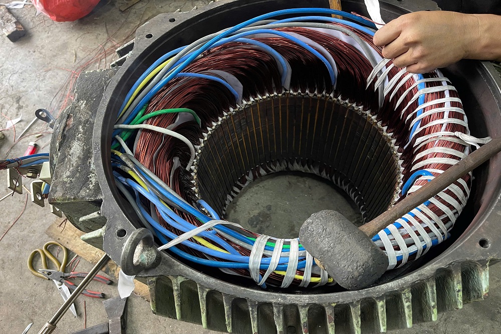 VNS technician measuring an electric motor component during repair